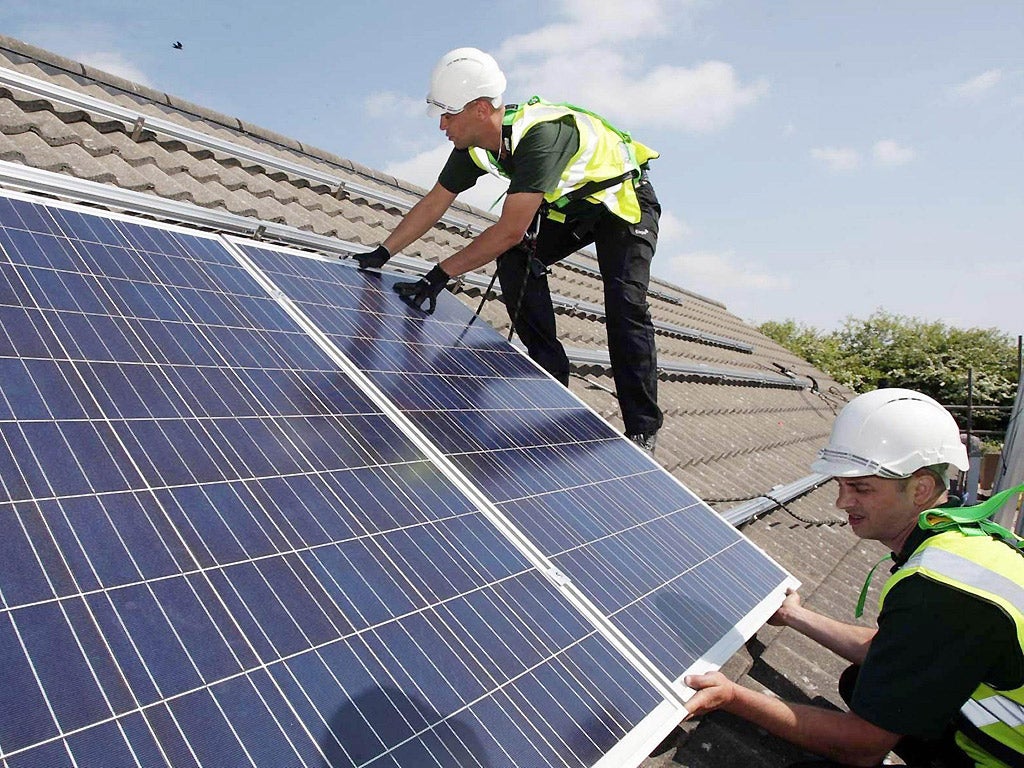 A 2011 photograph of workmen installing solar panels on homes in Delabole near Bodmin