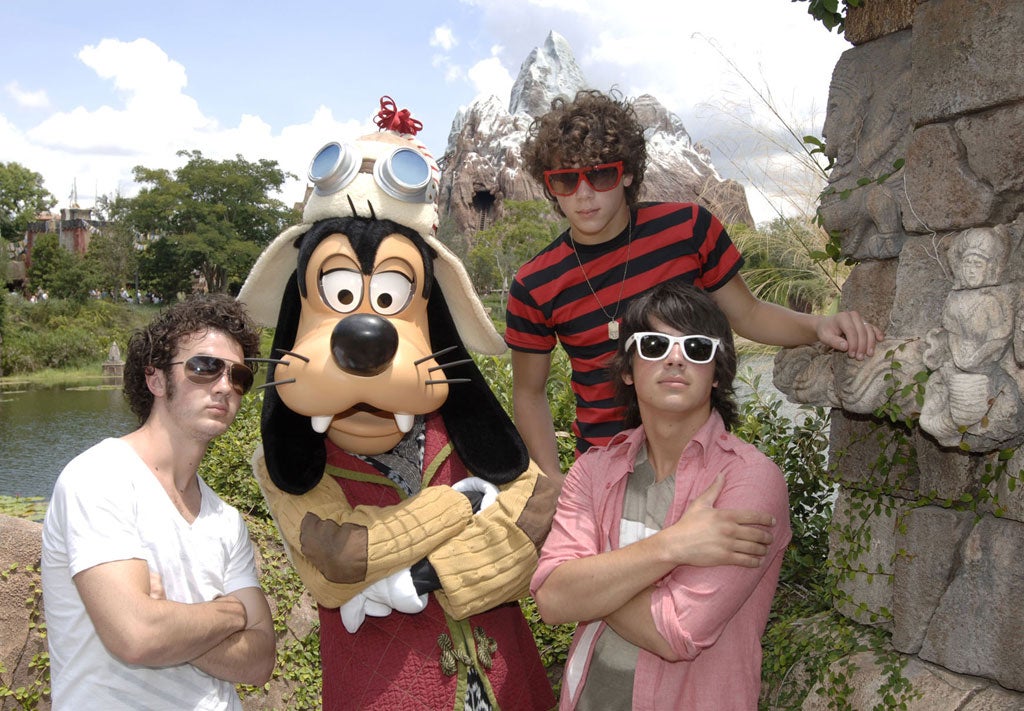The Jonas Brothers with Goofy at Walt Disney's Animal Kingdom Theme Park in Florida