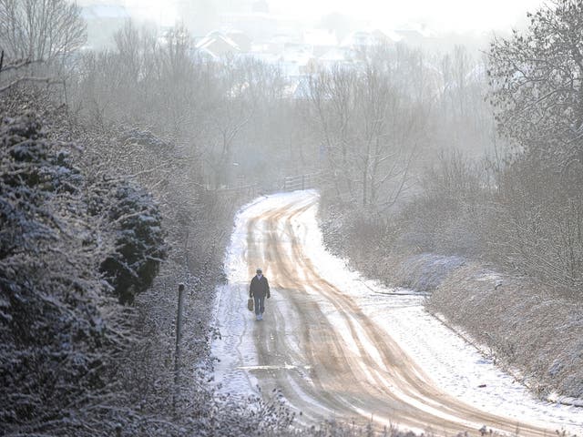 A woman walks along a snow covered road in Sixfields, Northampton