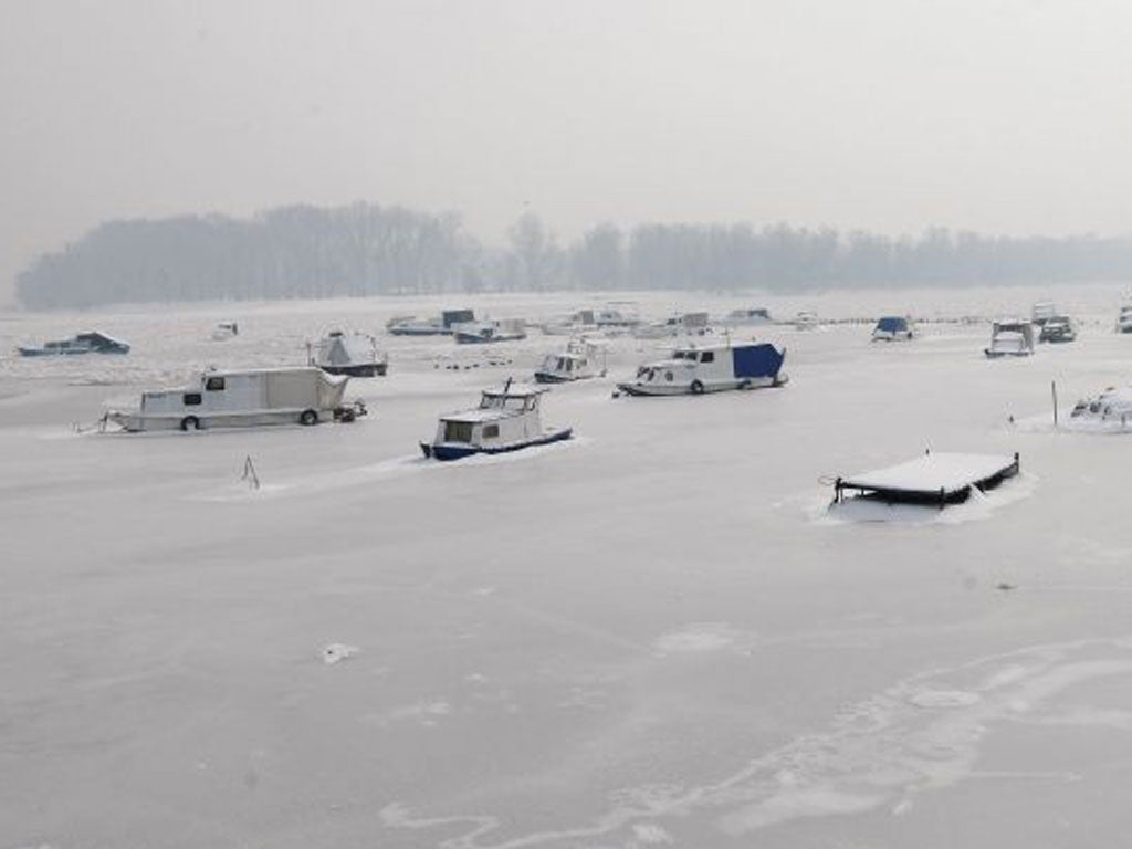 Boats are seen on a frozen stretch of theRiver Danube in the Serbian capital,Belgrade, yesterday. Army explosives teams have begun using dynamite to break up ice floes up to half a metre thick