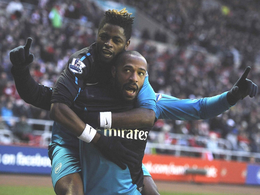 Thierry Henry celebrates his winning goal with Alex Song