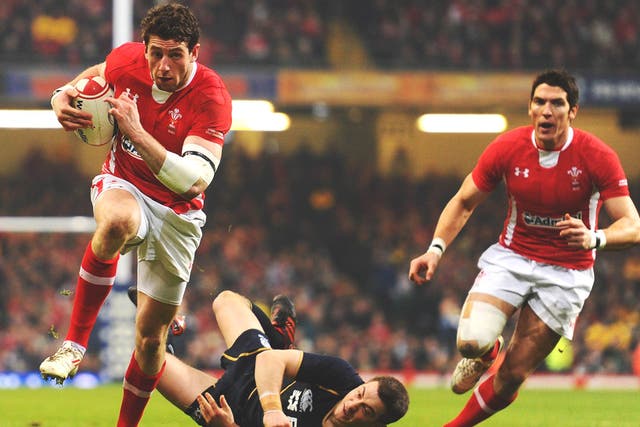 Alex Cuthbert, of Wales, breaks through the Scottish defence to score a try yesterday