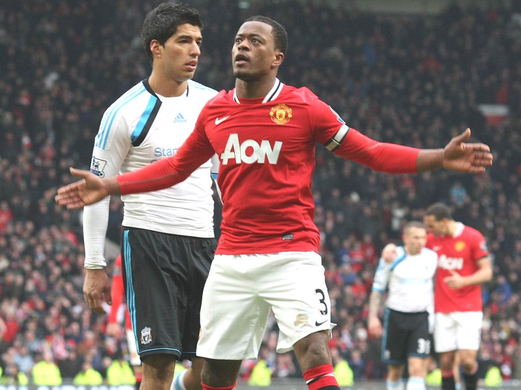 Patrice Evra celebrates in front of Luis Suarez after the final
whistle on Saturday