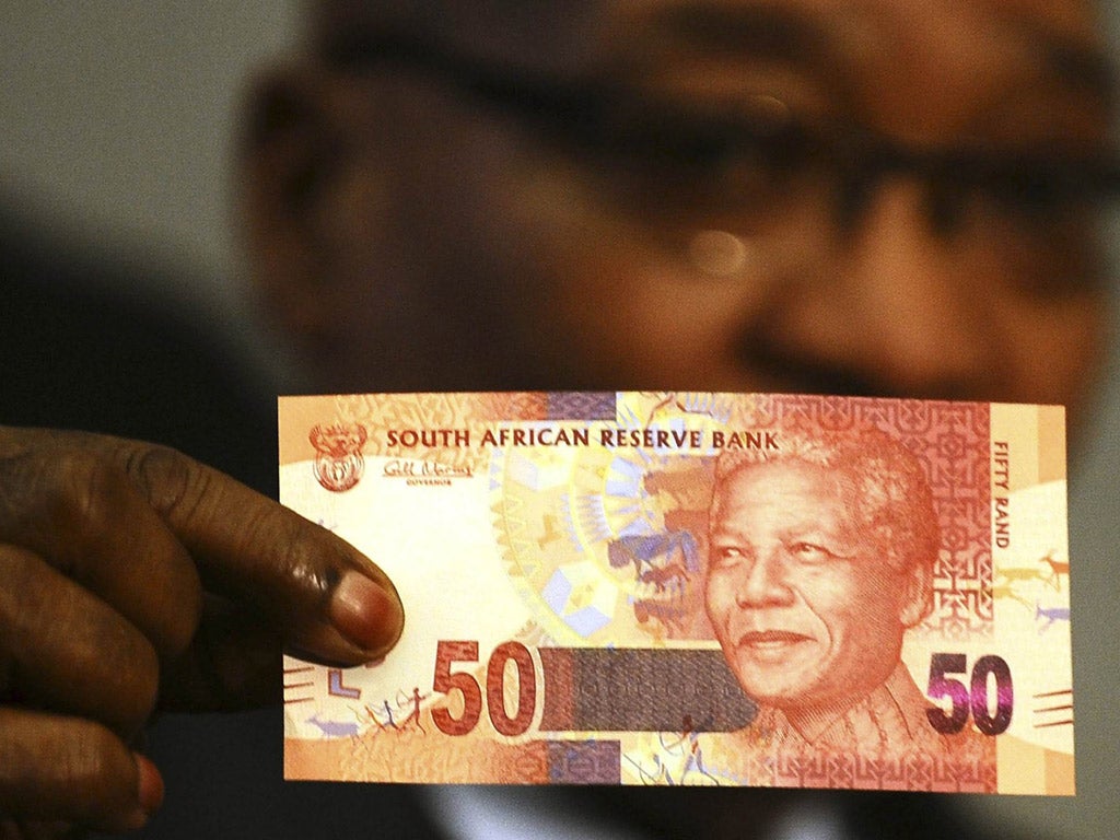 President Jacob Zuma holds up the new 50 rand note featuring the face of Nelson Mandela
