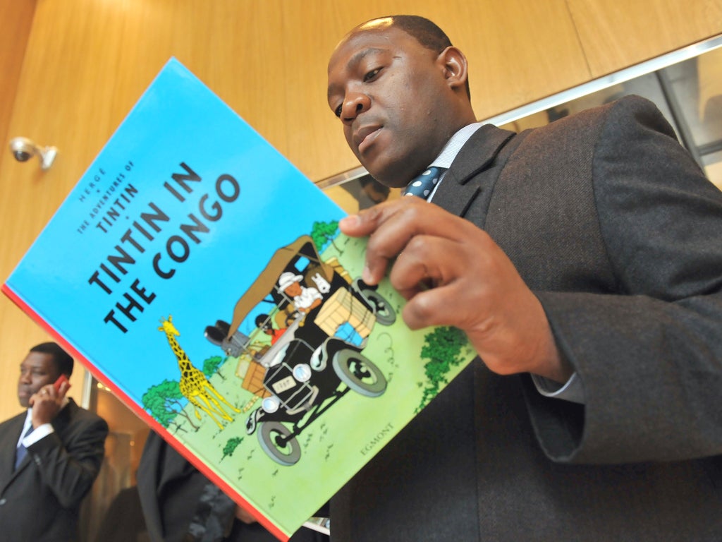 Bienvenu Mbutu Mondondo with a copy of the book he tried to ban