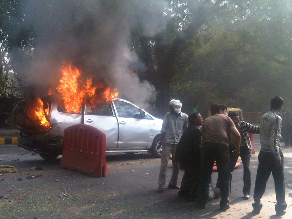 A person injured in the blast in Delhi is carried to safety yesterday