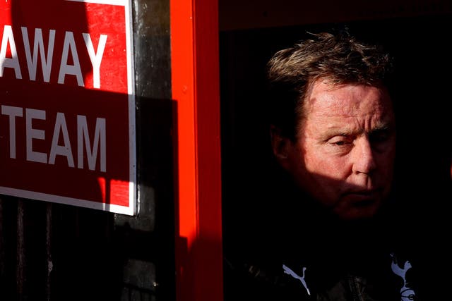 Tottenham Hotspur manager Harry Redknapp sits in the away dug-out