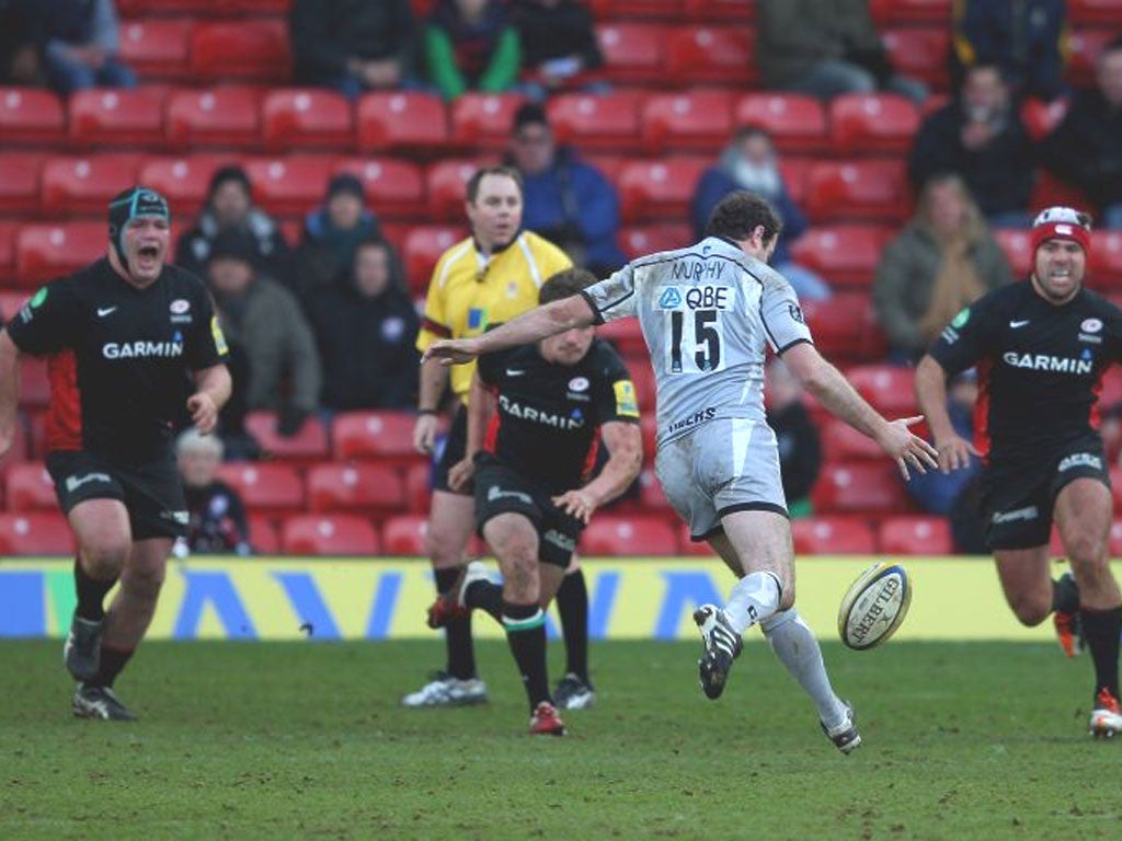 Leicester’s Geordan Murphy kicks the winning drop goal to defeat Saracens at Vicarage Road yesterday
