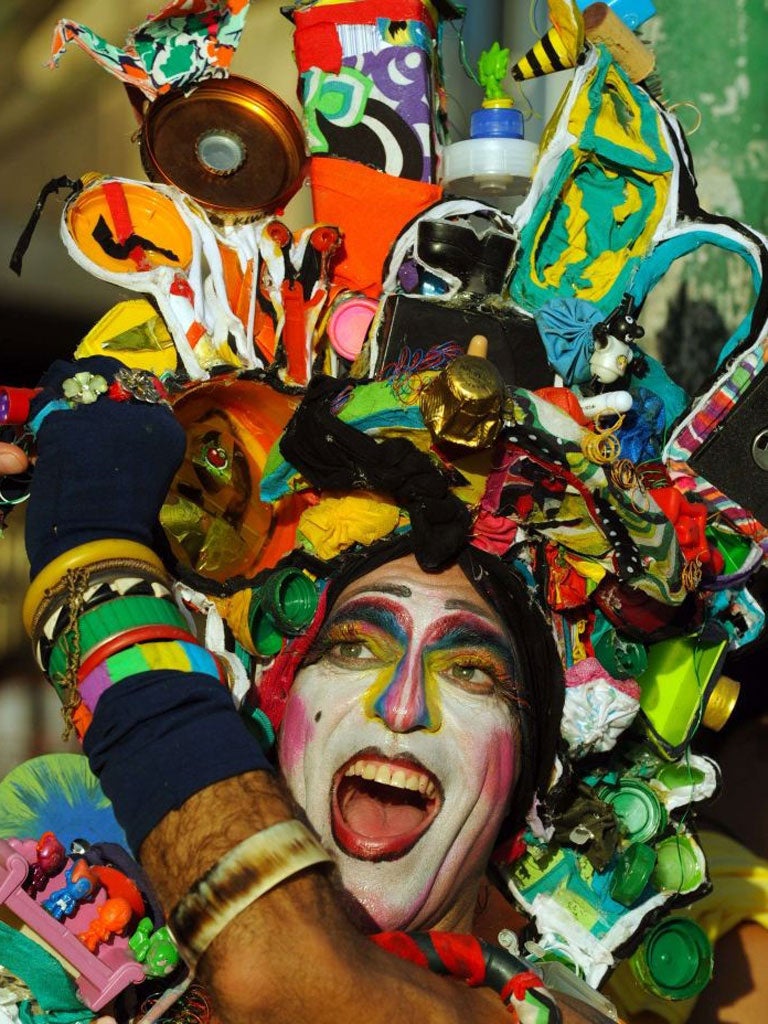 A reveler performs during the Banda de Ipanema carnival street band parade along in Rio de Janeiro