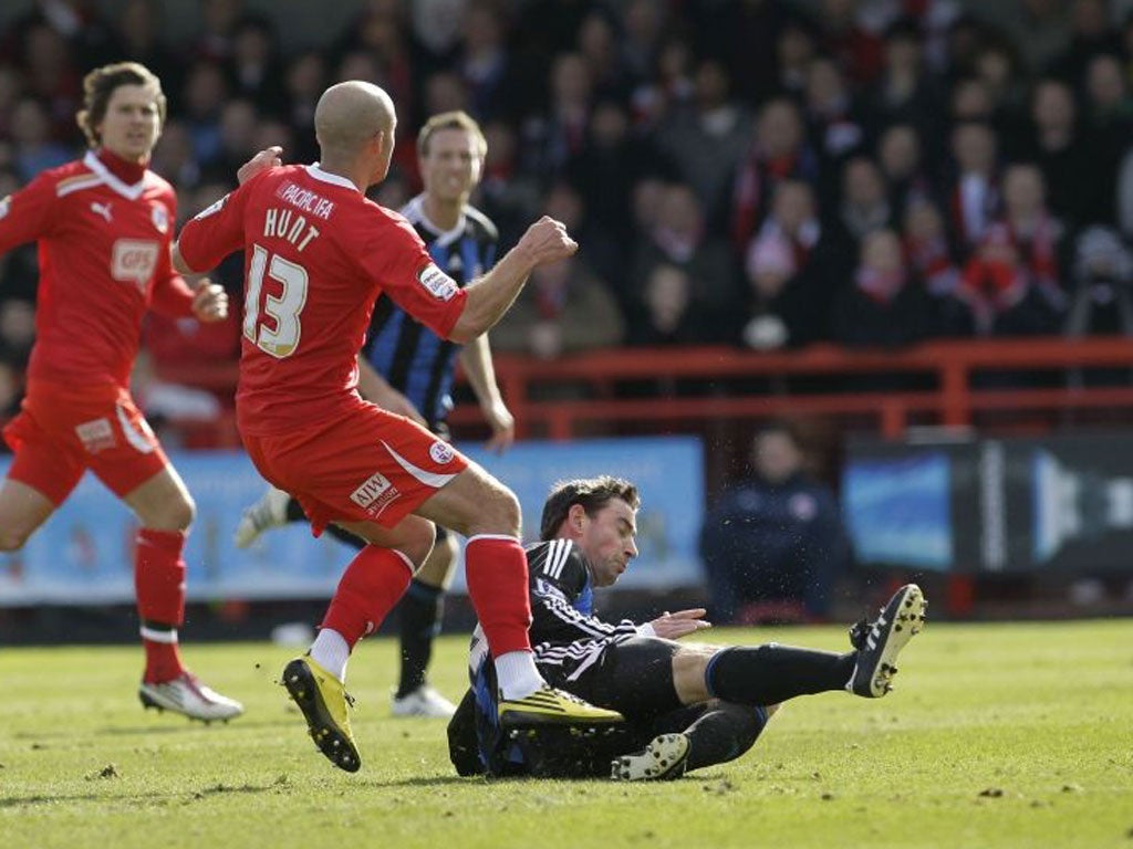 Rory Delap slides in to tackle Crawley Town’s David Hunt