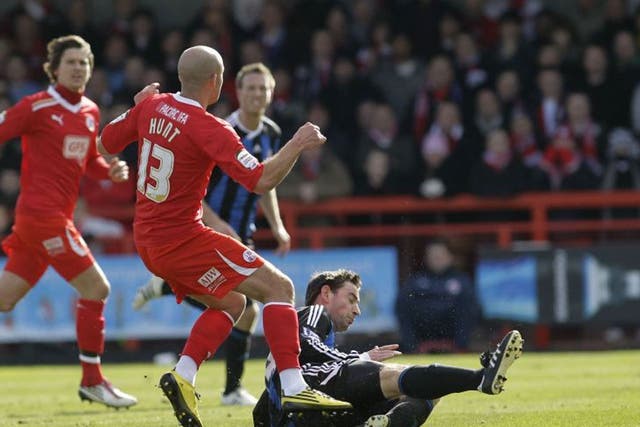 Rory Delap slides in to tackle Crawley Town’s David Hunt