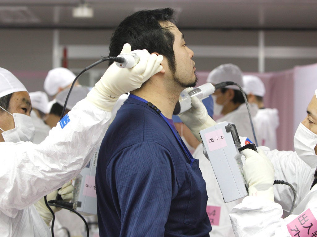 A worker is scanned for radiation as he enters the
emergency operation centre