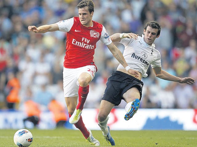 Carl Jenkinson (left) could face Gareth Bale again on Sunday, if he proves his fitness with Arsenal's reserves