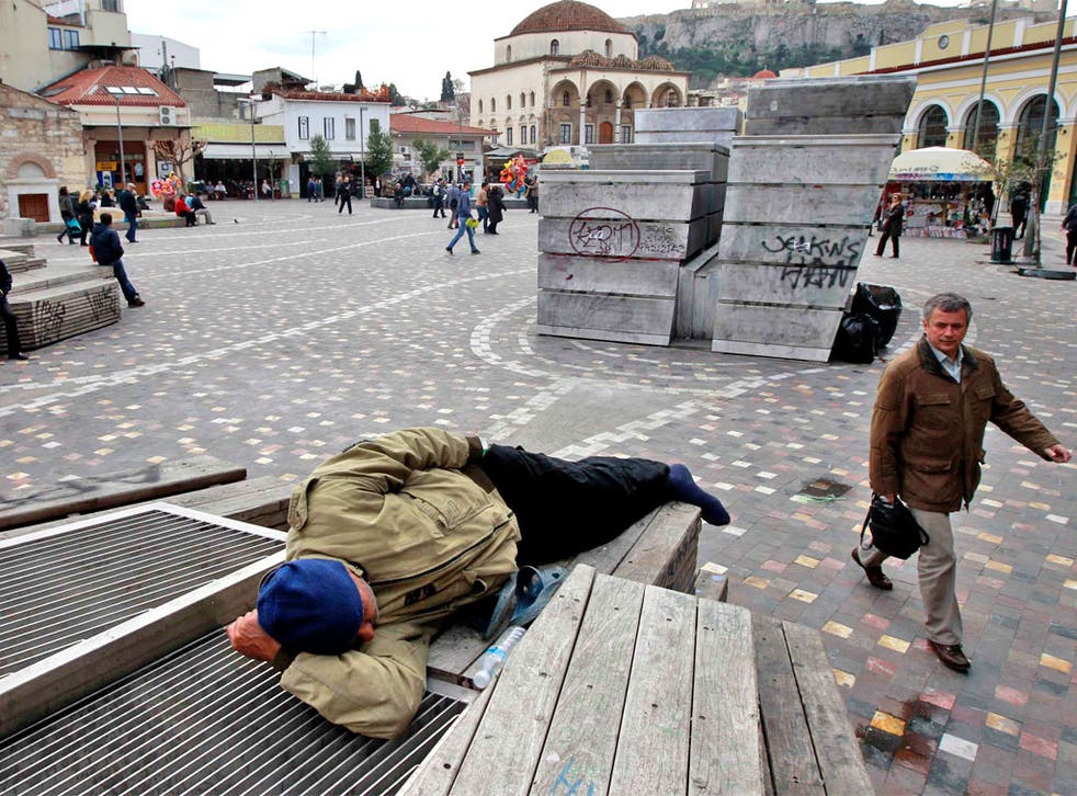 A man rests at Monastiraki square in central Athens yesterday