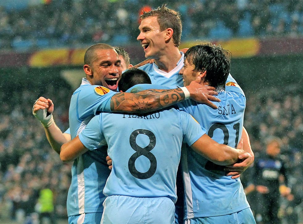 Manchester City players celebrate their side's fourth