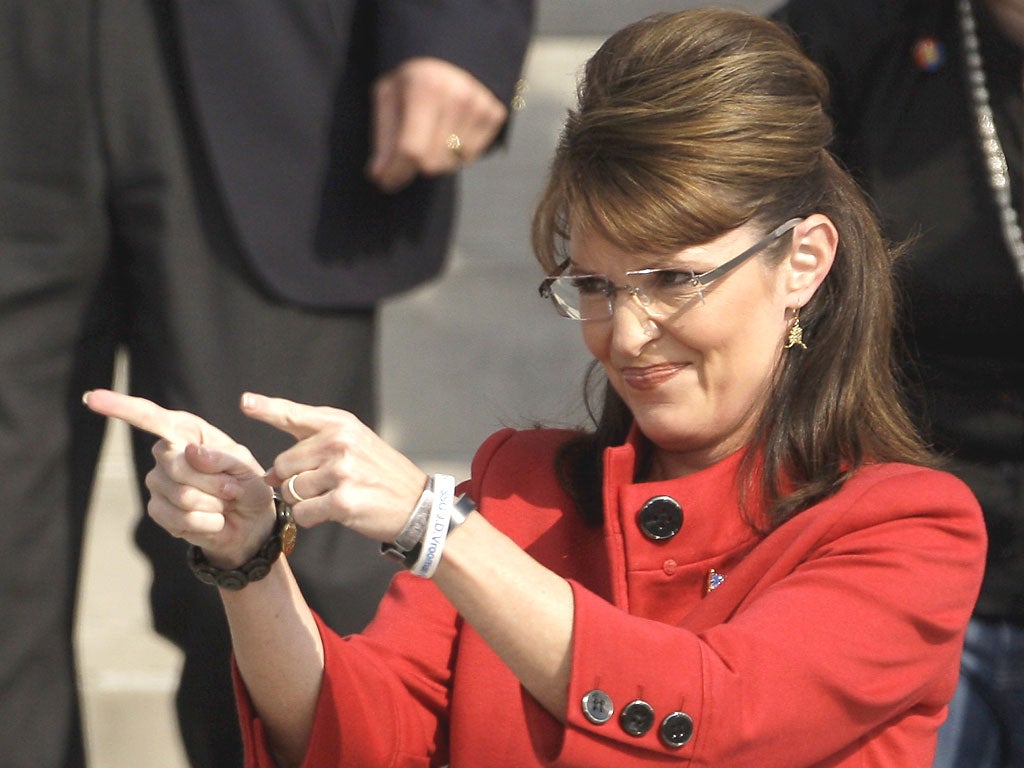 The real Sarah Palin greets the crowd during a 2008 election rally