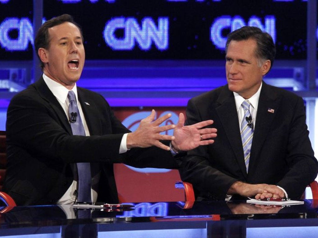 Rick Santorum, left, makes his voice heard in the Arizona debate