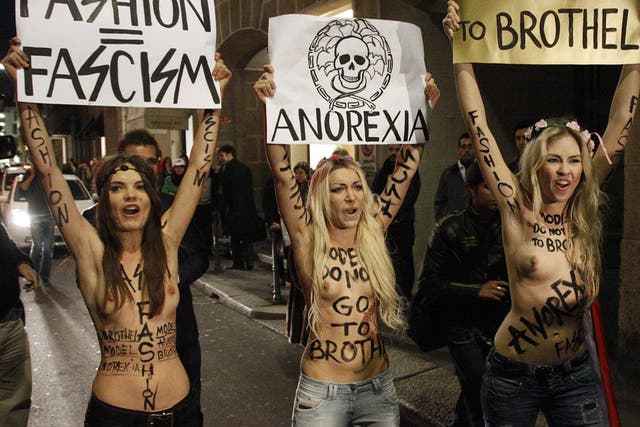 February 24, 2012: Activists from Ukrainian women's rights movement Femen, demonstrate in front of the Versace show during Milan Fashion Week in Milan.