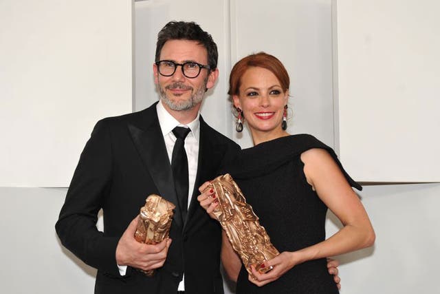 French director and screenwriter Michel Hazanavicius and French actress Berenice Bejo pose with their trophies for The Artist.