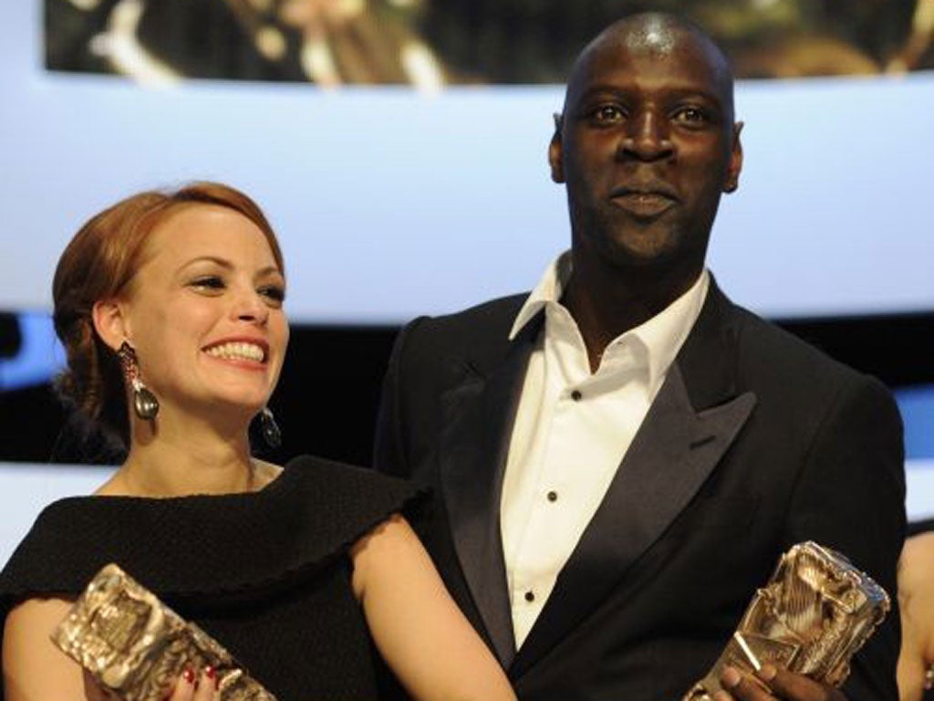 Omar Sy, star of Intouchables, right, is the first black person to receive the Best Actor award. He is pictured with Bérénice Bejo with her Best Actress César for The Artist