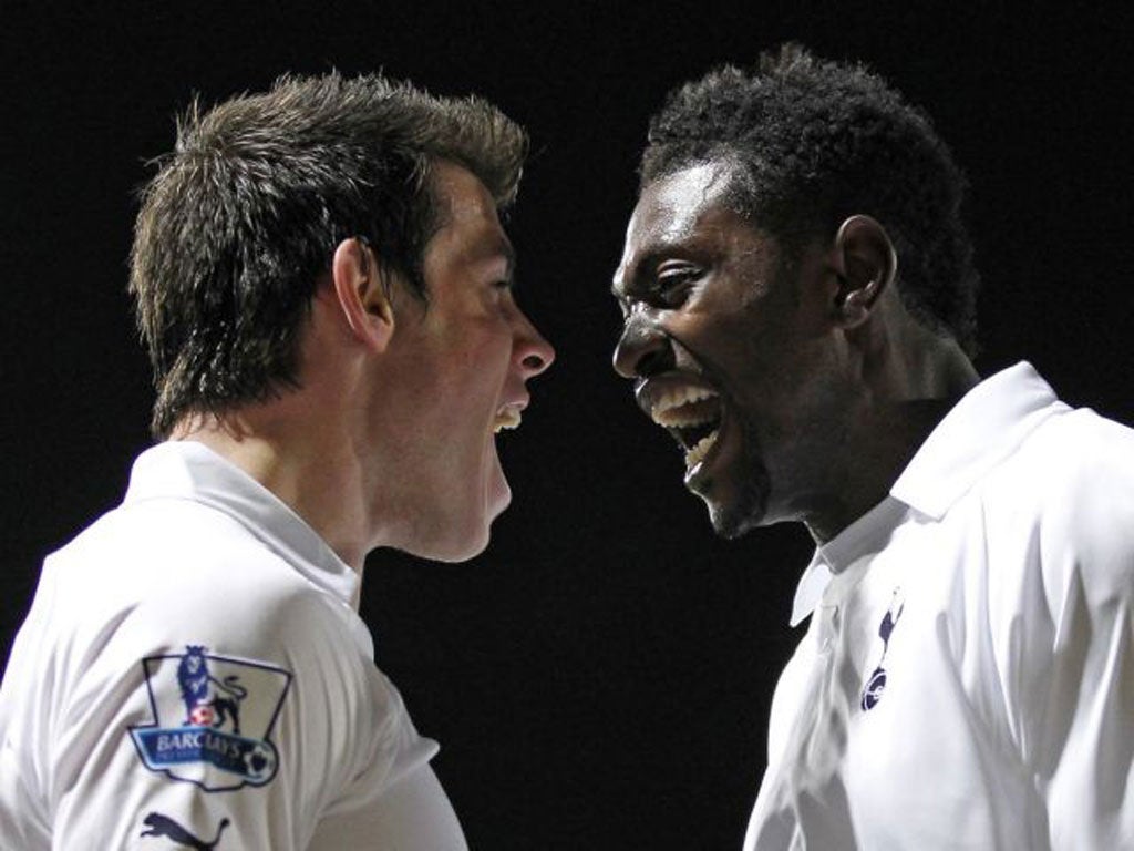 Emmanuel Adebayor (right) celebrates another strike for Tottenham with Gareth Bale. 'He can hold it up, head it, he's a handful,' says Michael Dawson