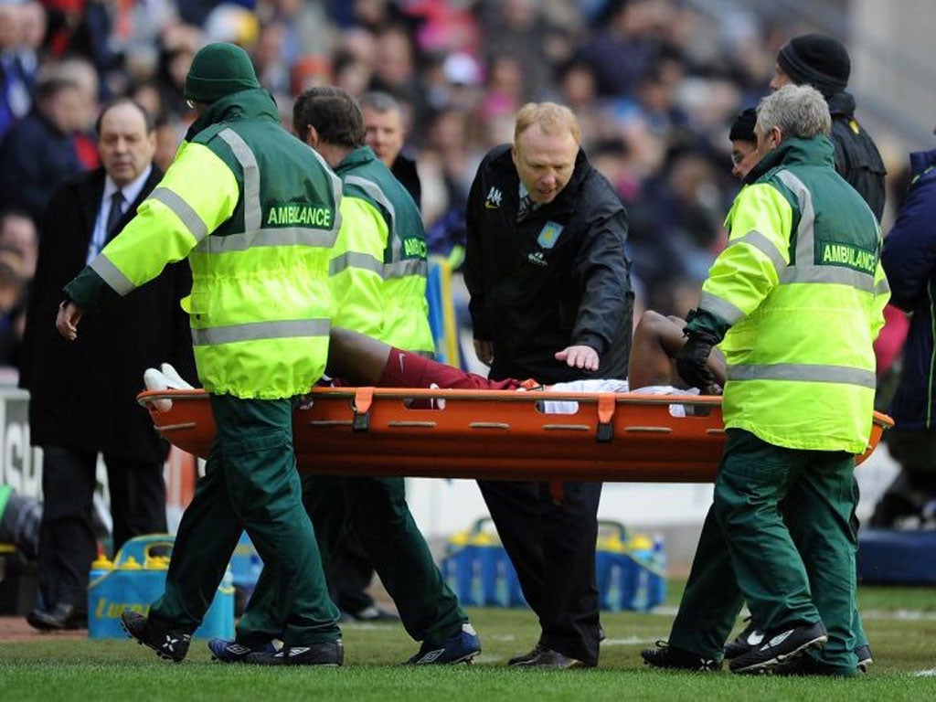 Alex McLeish looks concerned as Villa's Darren Bent is stretchered off