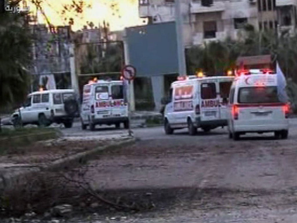 An image grab taken off the official Syrian TV shows Red Crescent ambulances in the besieged Syrian city of Homs as they attempt to evacuate Syrians wounded in shelling by regime forces as well as some women and children