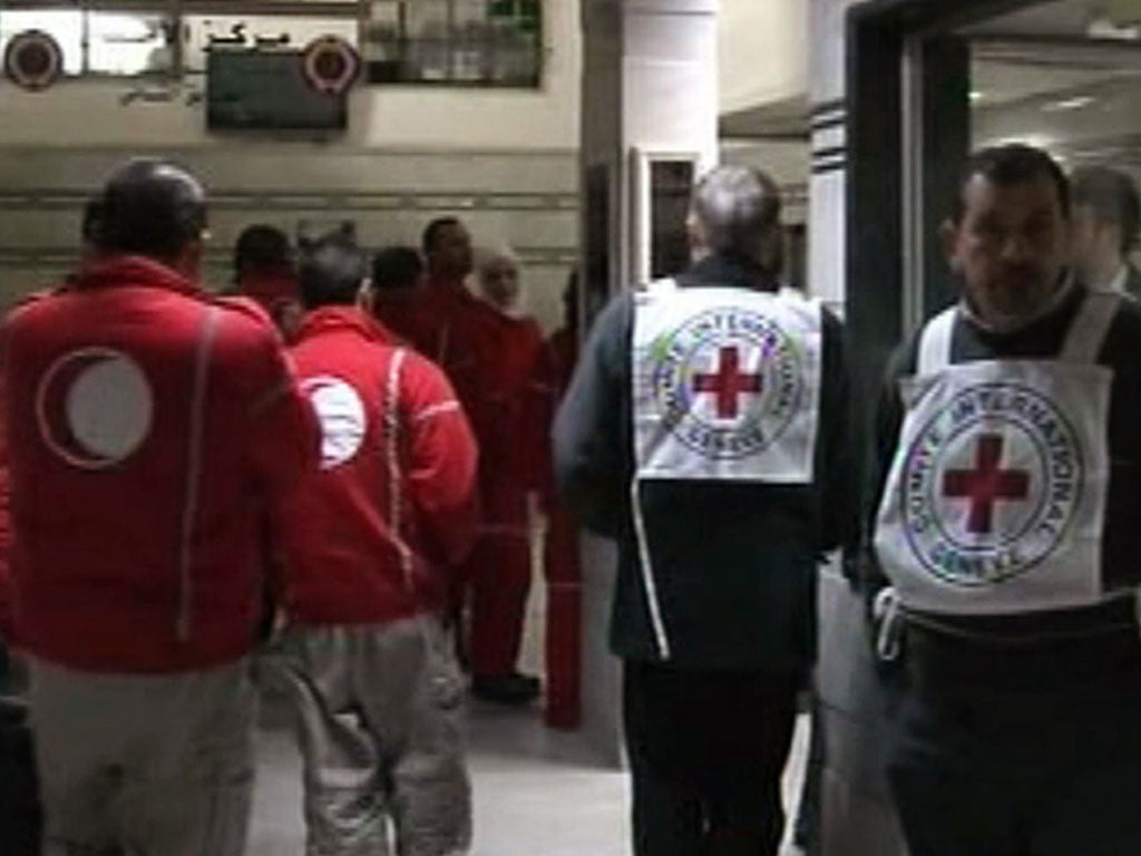 File: An image grab taken off the official Syrian TV shows Red Crescent and Red Cross medics at a hospital in the Syrian city of Homs as they attempt to evacuate Syrians wounded in shelling by regime forces