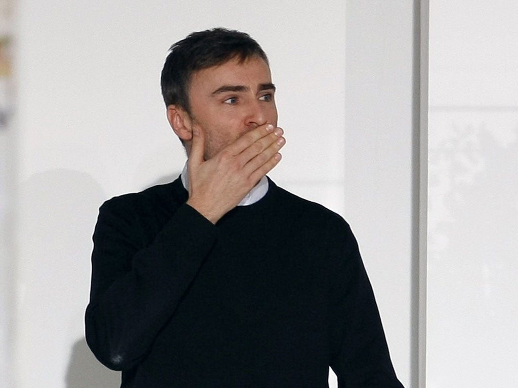 Belgian designer Raf Simons acknowledges the applause at the end of the Jil Sander 2012 Autumn/Winter collection during Milan Fashion Week