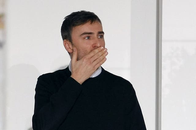 Belgian designer Raf Simons acknowledges the applause at the end of the Jil Sander 2012 Autumn/Winter collection during Milan Fashion Week