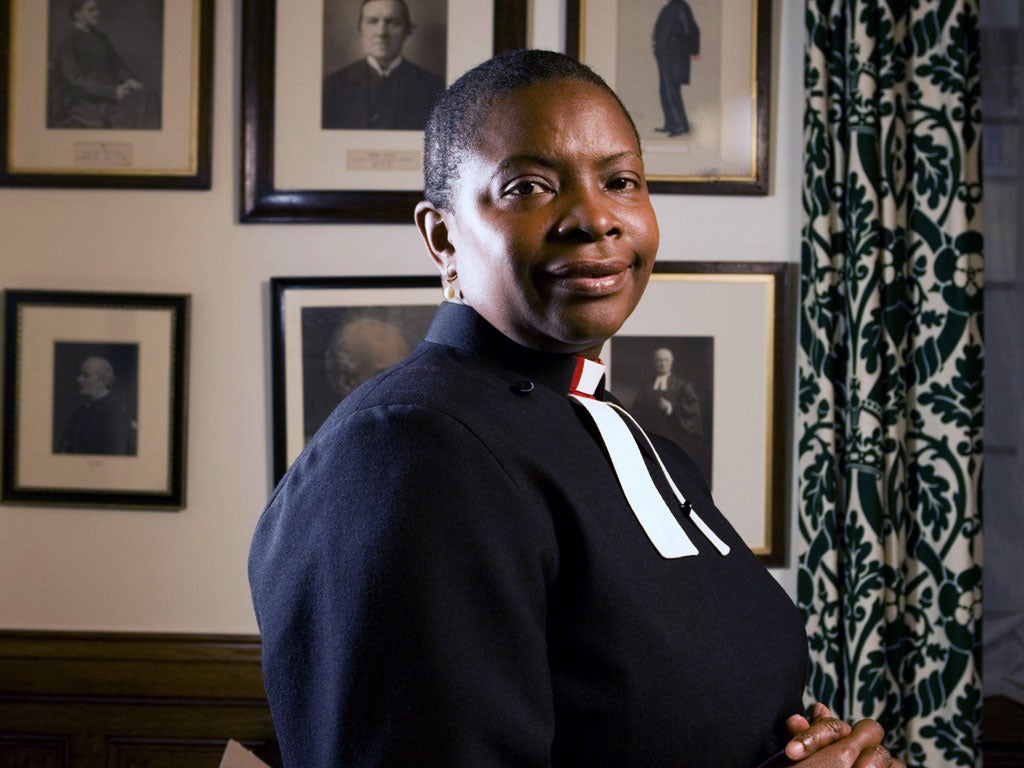 The Reverend Rose Hudson-Wilkin in her office at the House of Commons, behind her on the wall are pictures of her predecessors in the post of Chaplain