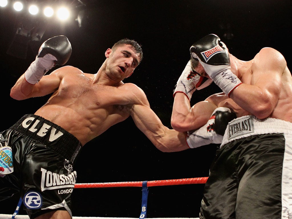 Nathan Cleverly (left) finds the ribs of Tommy Karpency in Cardiff