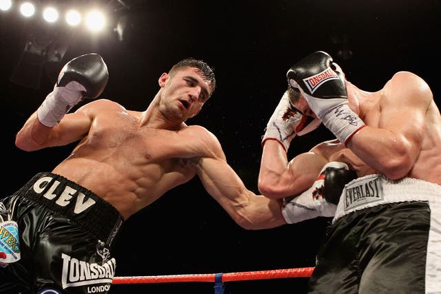 Nathan Cleverly (left) finds the ribs of Tommy Karpency in Cardiff