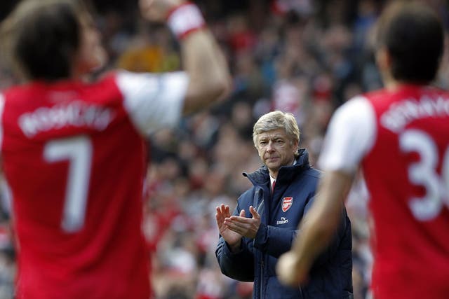 Arsene Wenger, Manager of Arsenal, applauds whilst Arsenal's Czech Republic player Tomas Rosicky (L) celebrates scoring 
