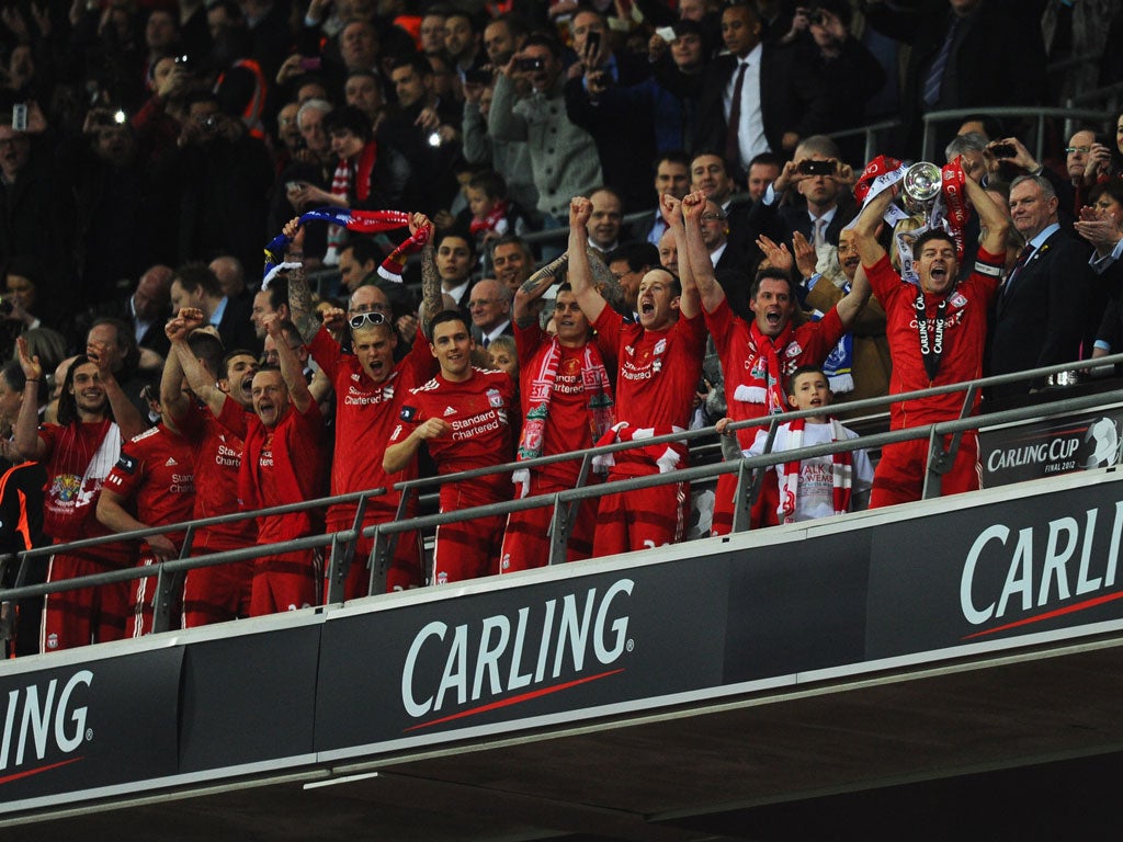 Steven Gerrard of Liverpool lifts the trophy in victory after the Carling Cup Final match between Liverpool and Cardiff City