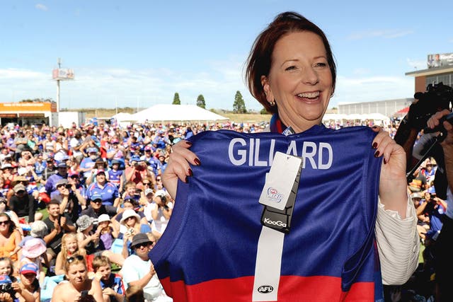 Charm offensive: Prime Minister Julia Gillard poses with the colours of the Australian rules football team Western Bulldogs at the club’s family day in Melbourne