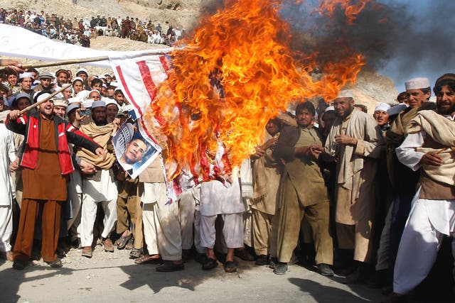Afghan demonstrators burn a US flag in Jalalabad province on Friday