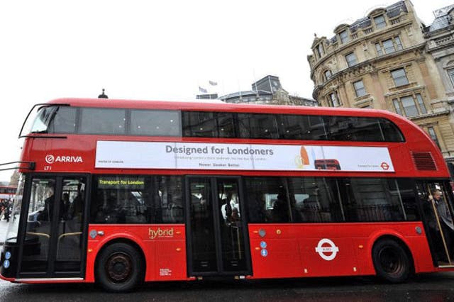 The new London bus driving through central London 