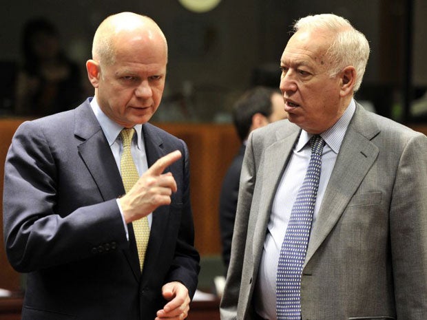 William Hague (left) speaks to his Spanish counterpart Jose Manuel Garcia at the talks in Brussels
