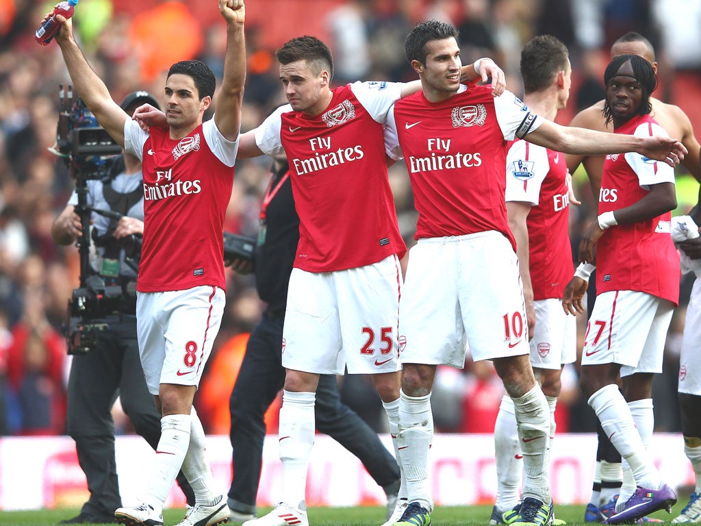 Arsenal’s Mikel Arteta, Carl Jenkinson and Robin van Persie celebrate beating Spurs