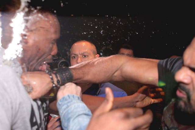 David Haye (right) hits Dereck Chisora during their press
conference brawl in Germany