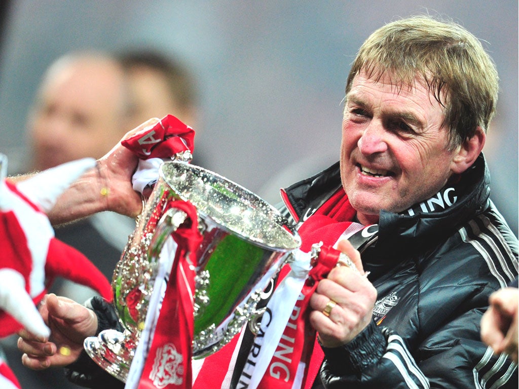 Kenny Dalglish grasps the Carling Cup, Liverpool’s first
trophy in six years