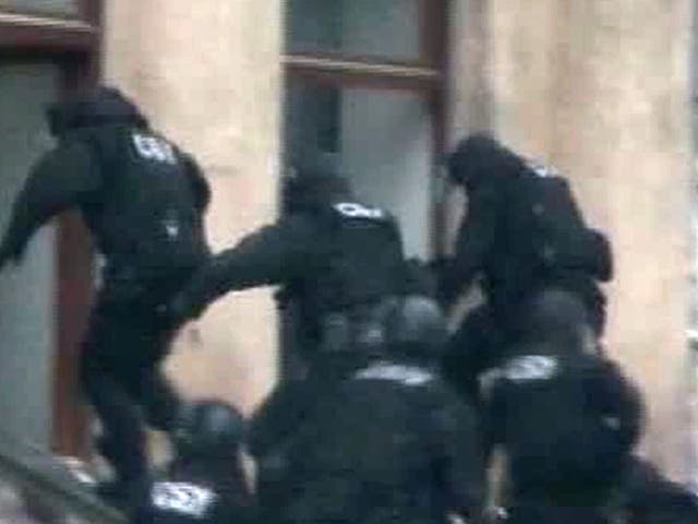 Channel One footage shows Adam Osmayevunder the escort of masked agents following their raid in Odessa