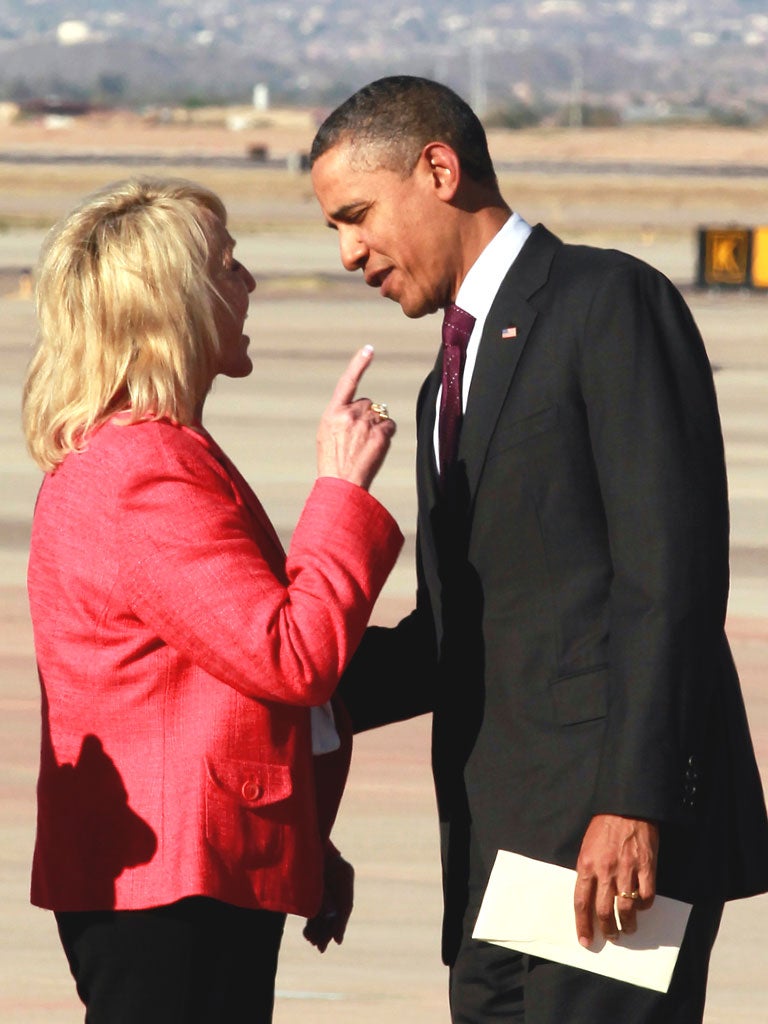 Governor Jan Brewer holds an intense conversation with Barack Obama at Arizona’s Phoenix-Mesa Gateway Airport last month