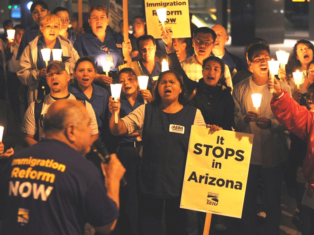 Mexican and Latino janitors hold a candlelight vigil calling for federal immigration reform
