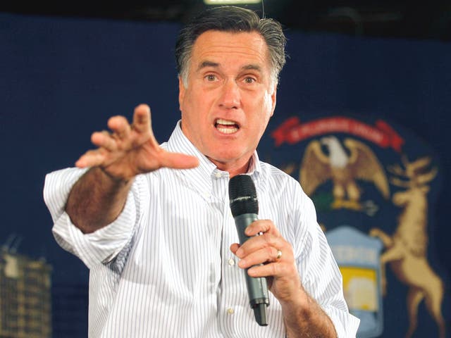 Mitt Romney greets supporters at a rally yesterday in Rockford, Michigan