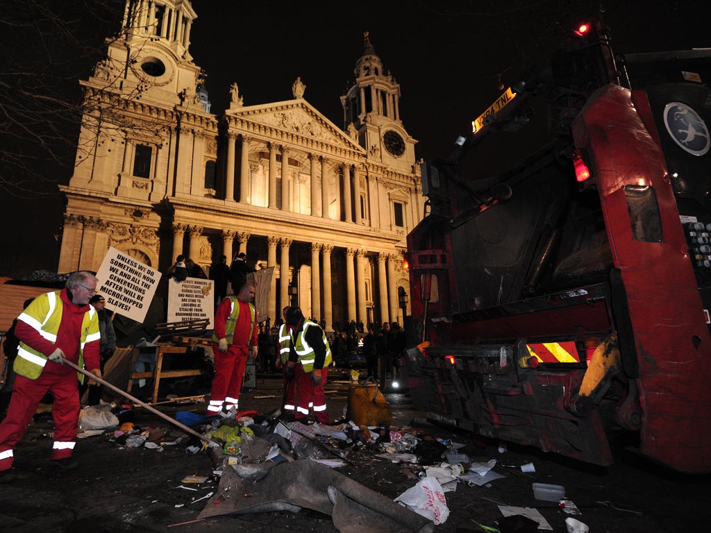 Debris is cleared away from the Occupy protest camp outside Saint Paul's Cathedral in central London as police and bailiffs evict demonstrators.
