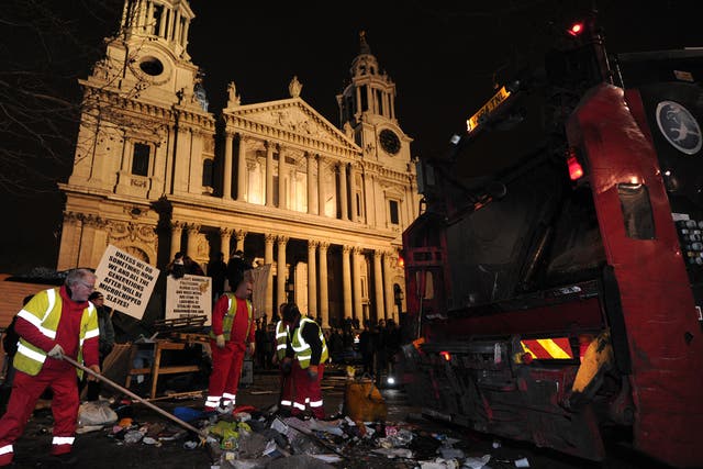 Debris is cleared away from the Occupy protest camp outside Saint Paul's Cathedral in central London as police and bailiffs evict demonstrators.