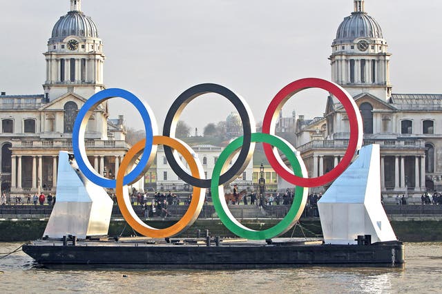 Olympic rings are towed on the Thames yesterday past the Royal Naval College at Greenwich, where equestrian events will be held in August