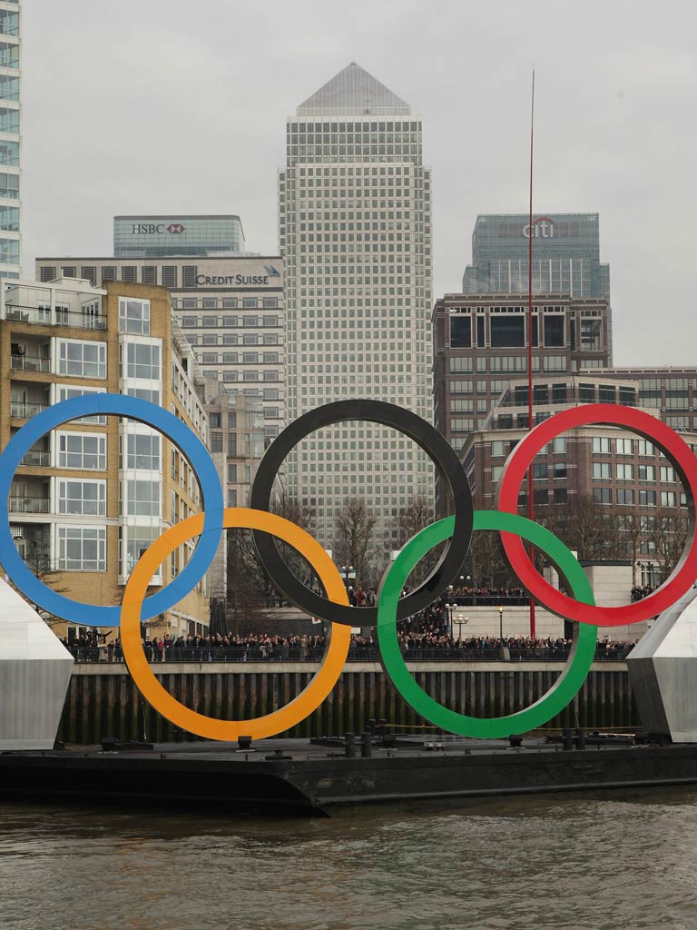 The Olympic rings pass Canary Wharf yesterday